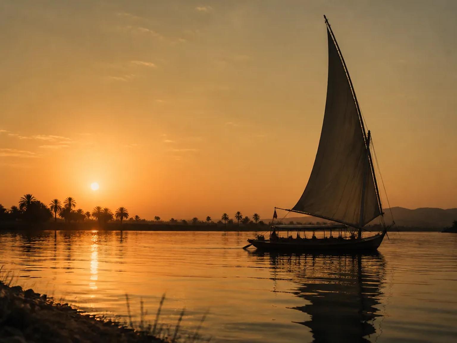 Felucca silhouette on the Nile at sunset – guides on every Discovery Tours Egypt itinerary are licensed Egyptologists