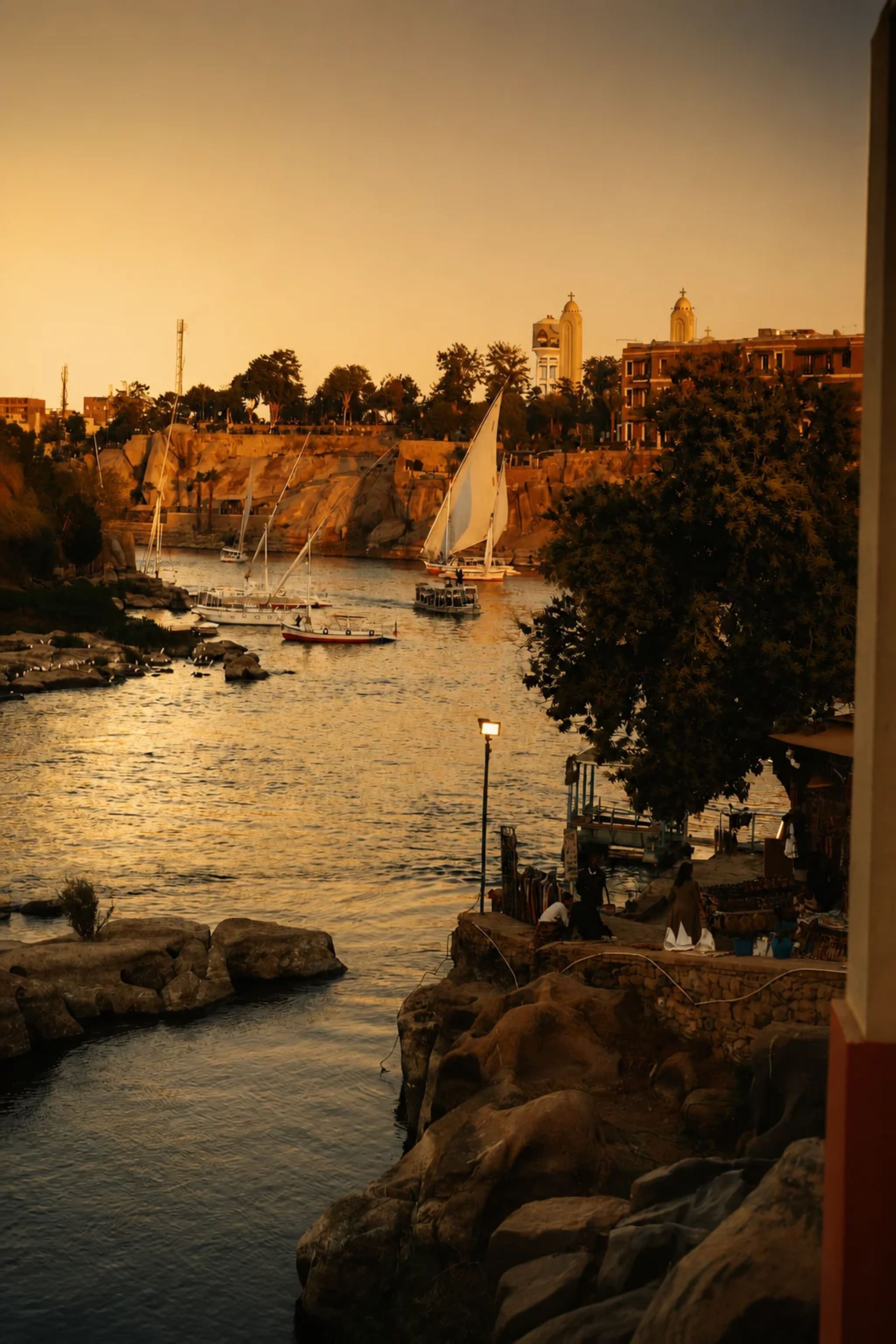 Feluccas on the Nile at Aswan with Philae temple beyond