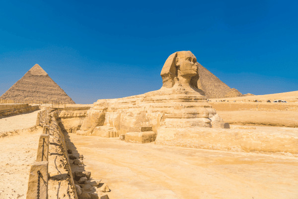 The Great Sphinx with pyramids in background