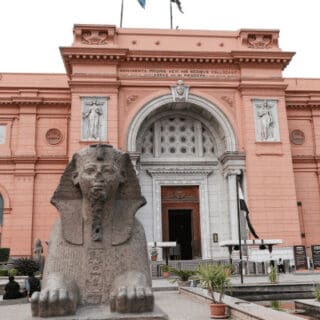 Egyptian Museum with a sphinx statue in foreground.