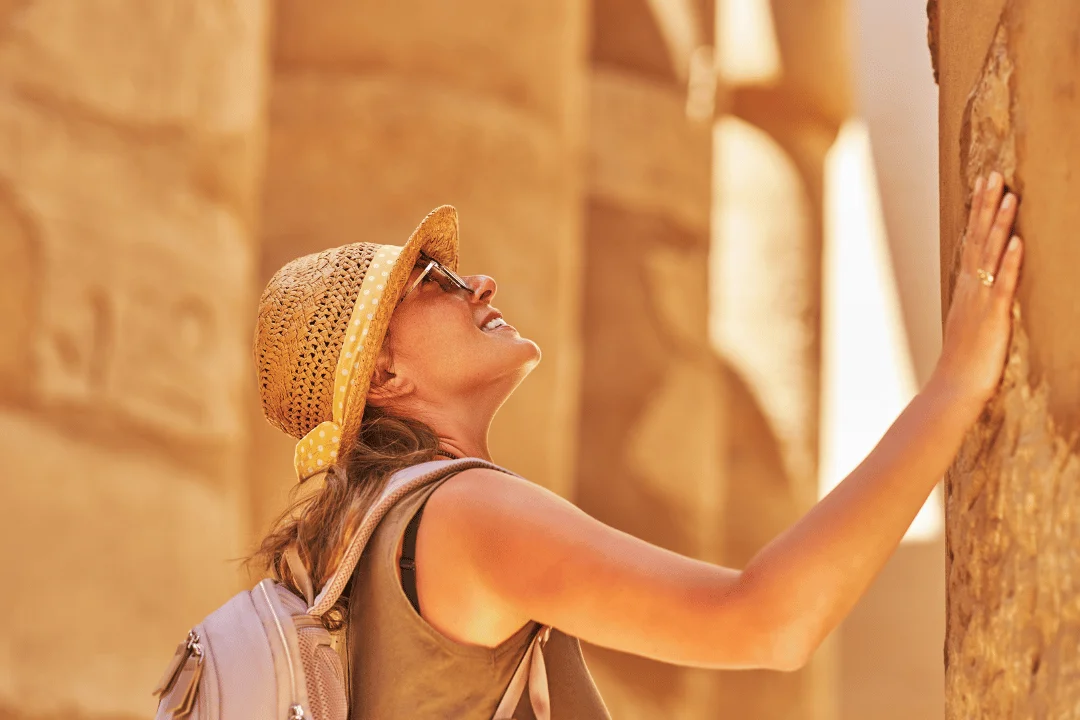 Visitor admiring ancient Egyptian columns.