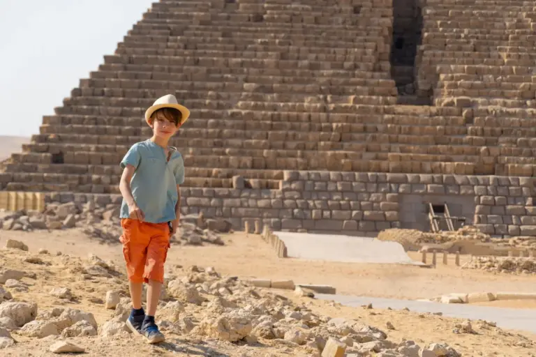 Boy walking in front of the pyramid of Mikerin on the Giza plateau