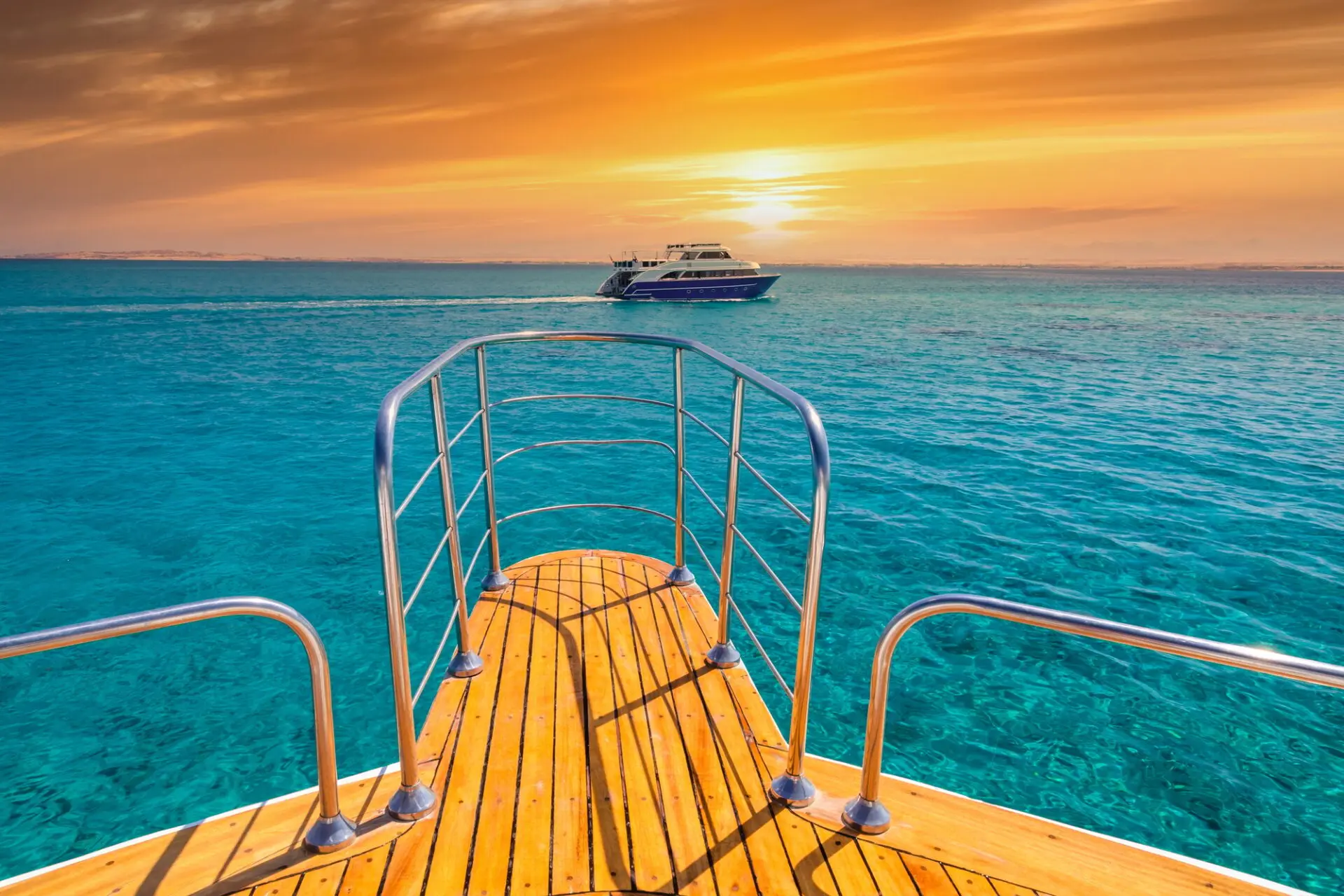 Cruise yacht bow in clear water near a coral reef. Red Sea, Egypt