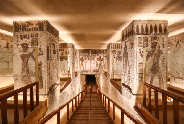 Ancient Egyptian tomb interior with intricate murals.