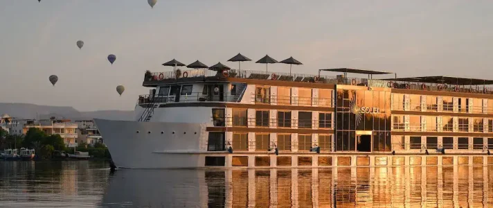 Luxury Soleil Nile River Cruise Sailing At Sunrise With Hot Air Balloons Over Luxor West Bank Behind The Nile River Cruise, Experienced With Discovery Tours Egypt.