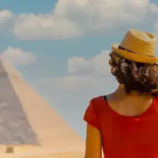 Woman admiring pyramids in Egypt during her Egypt Tours accompanied by Discovery Tours Egypt, an Egyptian DMC.