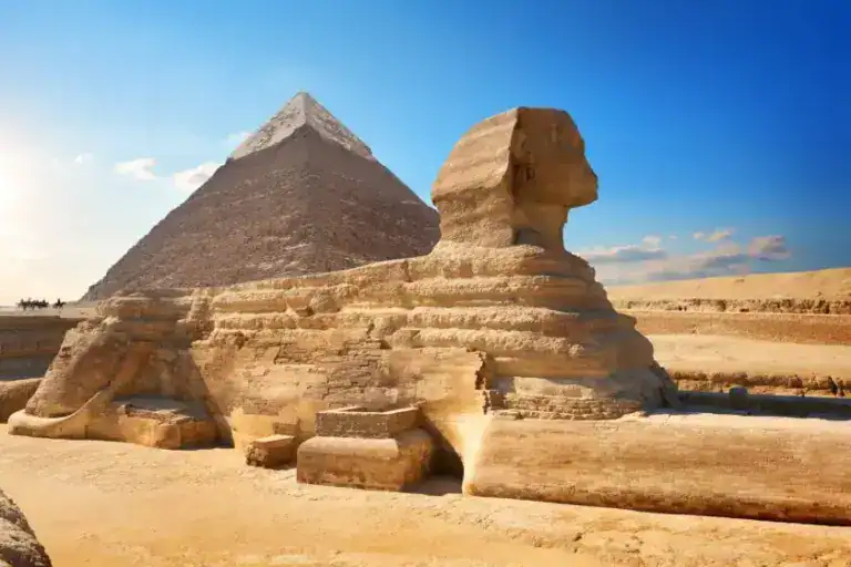 Ancient Sphinx With Pyramid Behind It Being Admired By Tourist On An Egypt Dmc Group Tour.