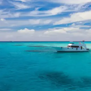 Cruise yacht bow in clear water near a coral reef. Red Sea, Egypt