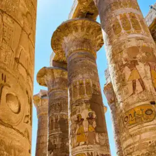 Close-up of ancient Egyptian columns with intricate carvings at Karnak Temple in Luxor. 17-Day Egypt Classic Tour Luxor Day Tour from Marsa Alam