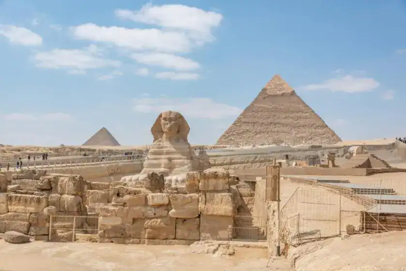 Iconic view of the Great Sphinx and Giza Pyramids in Egypt under a clear blue sky. Top Tourist Attractions