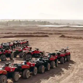 Large column of ATVs and buggies stands in the middle of a sandy desert. Ready for fun in the desert. Hurghada Desert Safari