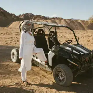 Woman tourist on quad bike ATV safari with desert background of Sharm El Sheikh Egypt Hurghada Morning Quad Safari: Bedouin Village & Camel Ride
