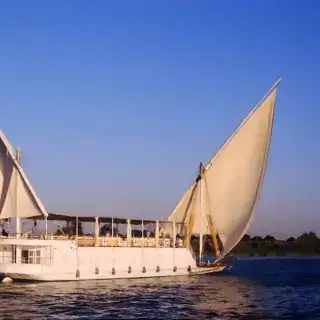 Dahabiya Loulia boat sailing on the Nile at sunset